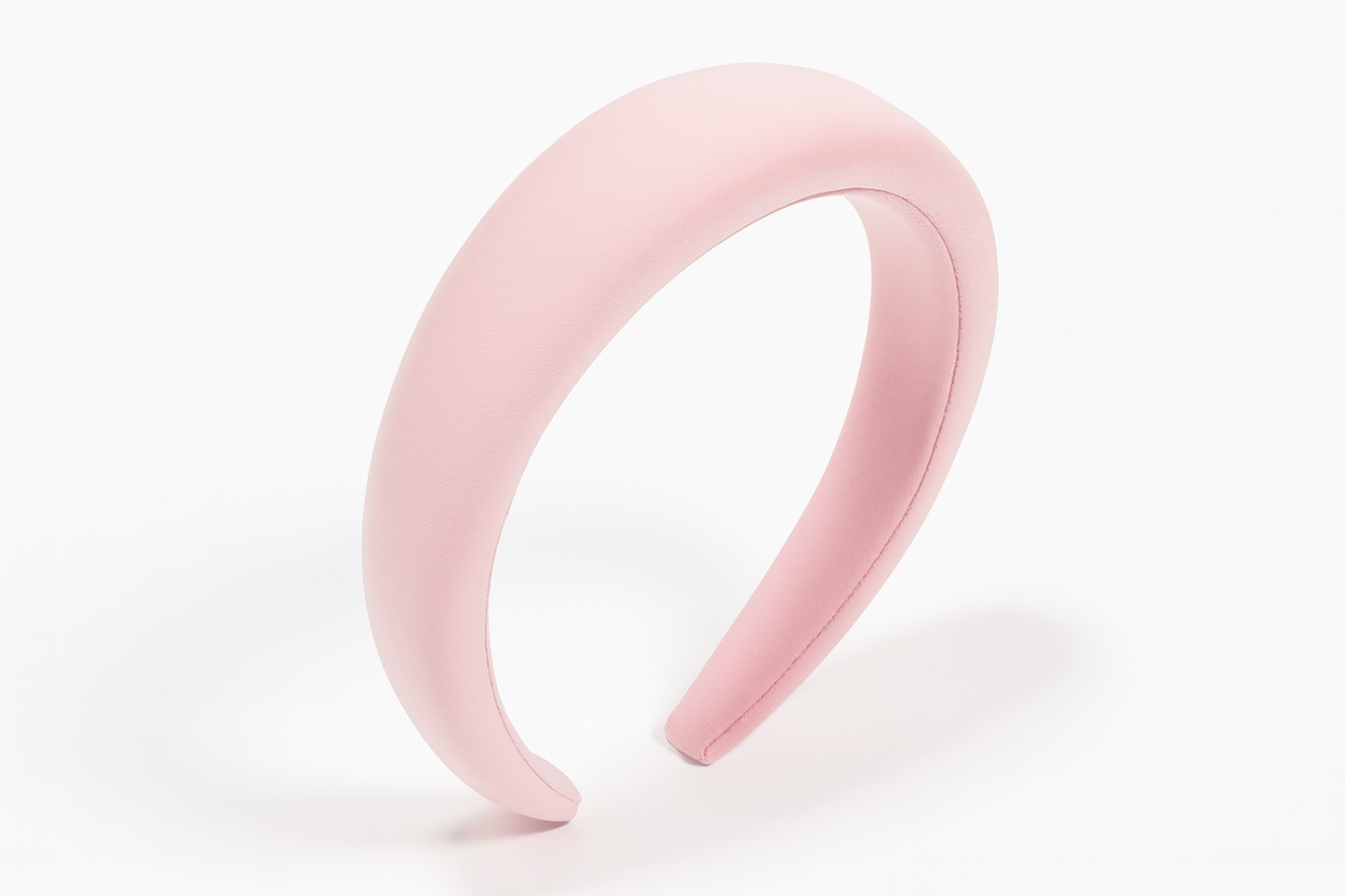 Light pink padded headband on white background